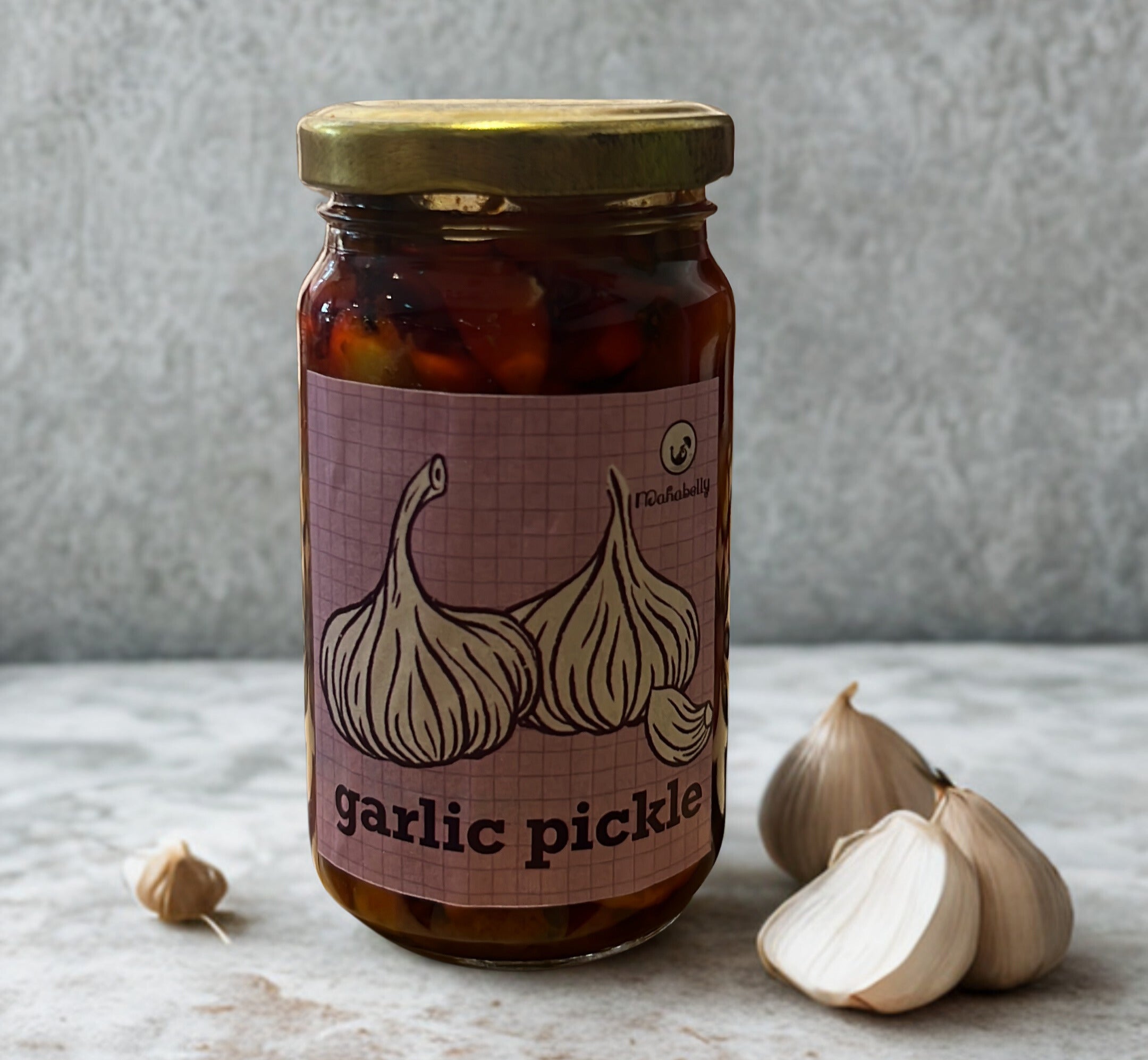 Jar of garlic pickle with a label featuring garlic illustrations